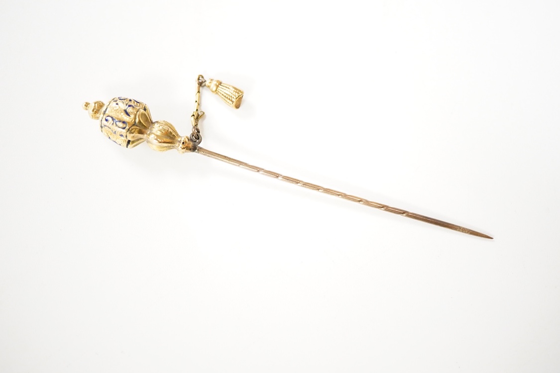 An early 20th century Viennese yellow metal, ruby, diamond and sapphire set 'clover' stick pin, 68mm, together with a yellow metal and blue enamel set stick pin.